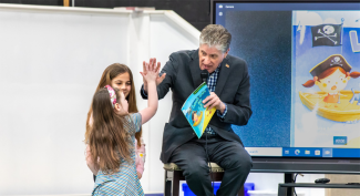 Governor Mckee and child doing a "High Five"