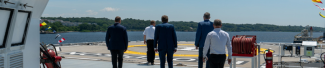 Gov Staff standing next to a helipad
