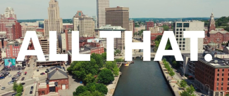 Drone shot of downtown Providence with "ALL THAT" overlaid on it