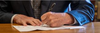 Governor signing a document